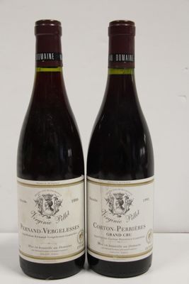 pair of two bottles of wine sitting on a white surface