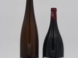two bottles of wine sitting next to each other on a table