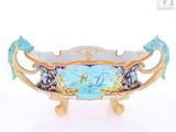 a blue and gold bowl sitting on a white surface