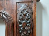 a wooden fireplace mantle with a clock on top of it