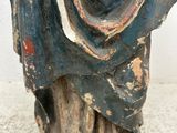 an old statue of a man with a beard and a blue robe