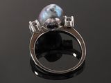 sterling silver ring with a black pearl and a silver band