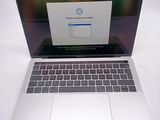 a laptop that is open on a white table