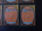 four decks of magic the gathering deck are shown on a table