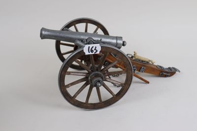 a toy cannon sitting on top of a wooden cart