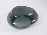 a black glass bowl sitting on a white surface