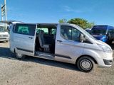 a silver van that is parked in a parking lot