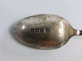a silver spoon with the word b b h on it