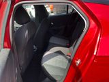 a red car with the door open and the seats down