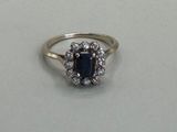 an image of a diamond and sapphire ring on a table