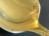 a spoon that has some liquid in it on a table