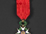 a medal with a red ribbon and a star on it