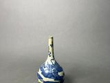 an old blue and white vase with a wave design on it