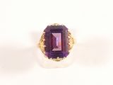 an image of a ring with a purple stone in it
