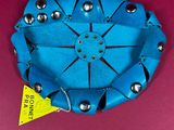a blue bowl with silver balls on it
