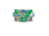 a close up of a green and blue ring on a white surface