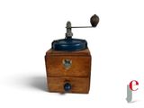 a small wooden grinder with a blue lid