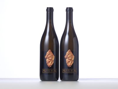two bottles of wine sitting on top of a table