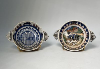 two small plates with designs on them sitting next to each other