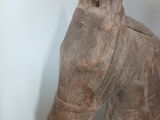 a wooden horse head on display in a room