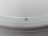 a white container with a green sticker on it