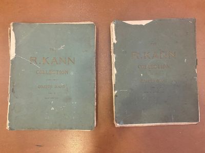 two books sitting on top of a wooden table next to each other