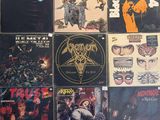 many different types of rock and metal albums on the wall