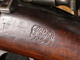 a close up of a rifle with a wooden handle