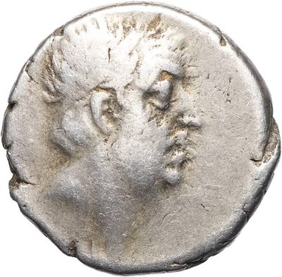 a silver coin with a head of a man on it