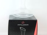 a clear glass vase sitting on top of a black box