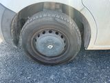 a white car with a flat tire on the road
