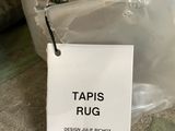 a stuffed bear in a plastic bag with a tag on it