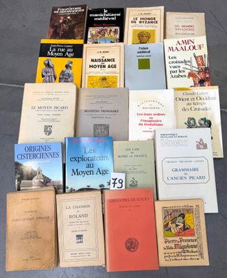 several books are stacked on top of each other on the floor