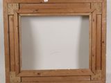 an old wooden picture frame with a small hole in the middle