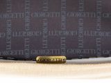 a close up of a purse with a name tag on it
