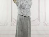 grey and white dress on a mannequin stand in a room