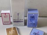 three boxes of colognes and a box of cologne on a table