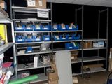a room filled with shelves and bins of assorted items