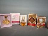 three small boxes of perfume sitting next to each other on a table
