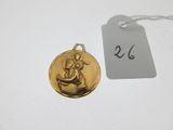 an image of a gold medal with a woman holding a child