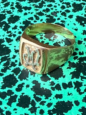 a close up of a ring on a green and black surface