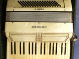 an old accordion sitting in a box on the floor