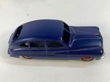 a blue toy car sitting on a table next to other toy cars