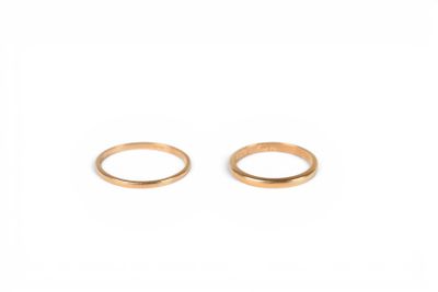 a pair of gold rings on a white background