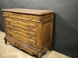 an antique chest of drawers with carved wood and marble top