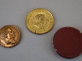 three different types of coins are shown on a white surface