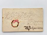an old letter with a pink ribbon on top of it