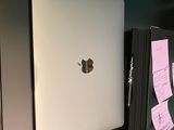 a white apple laptop sitting on a desk with sticky notes on it