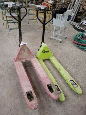 two forklifts sitting next to each other on the ground
