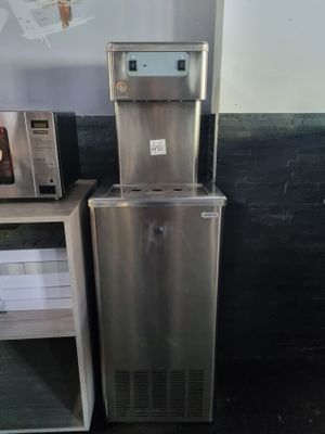 a silver refrigerator and a microwave in a room